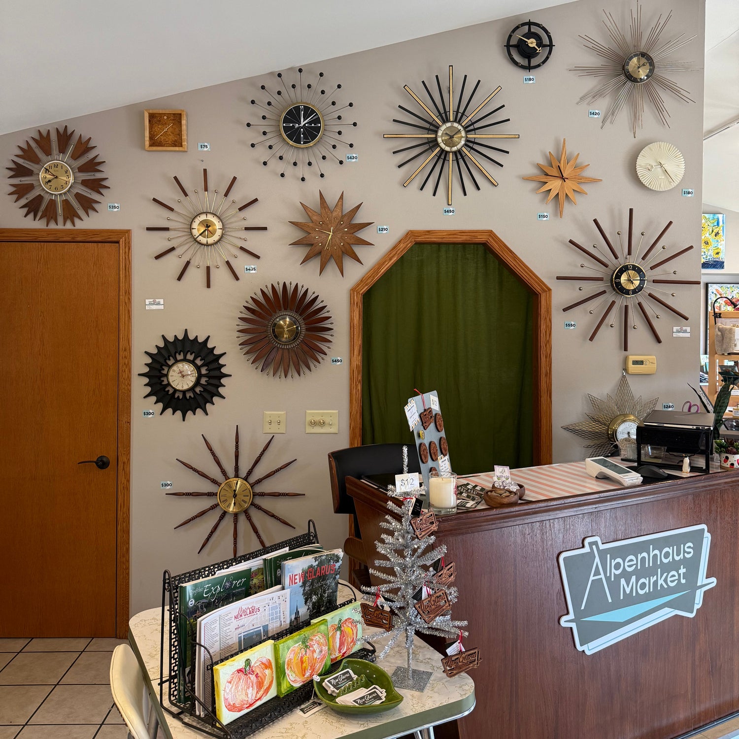 Decorative wall with various clock designs in a store setting