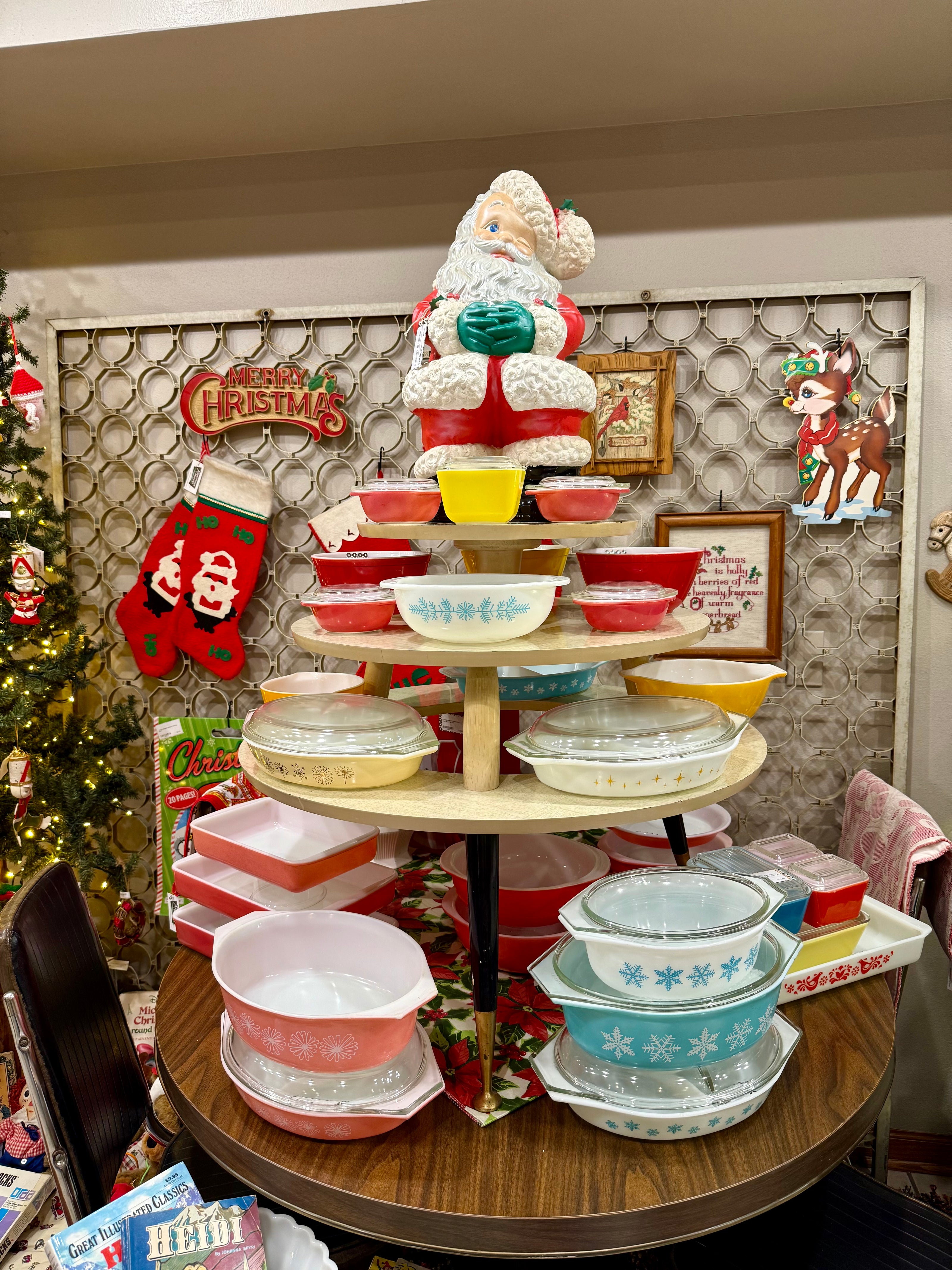 Decorative tiered stand with vintage pyrex dishes against a festive background