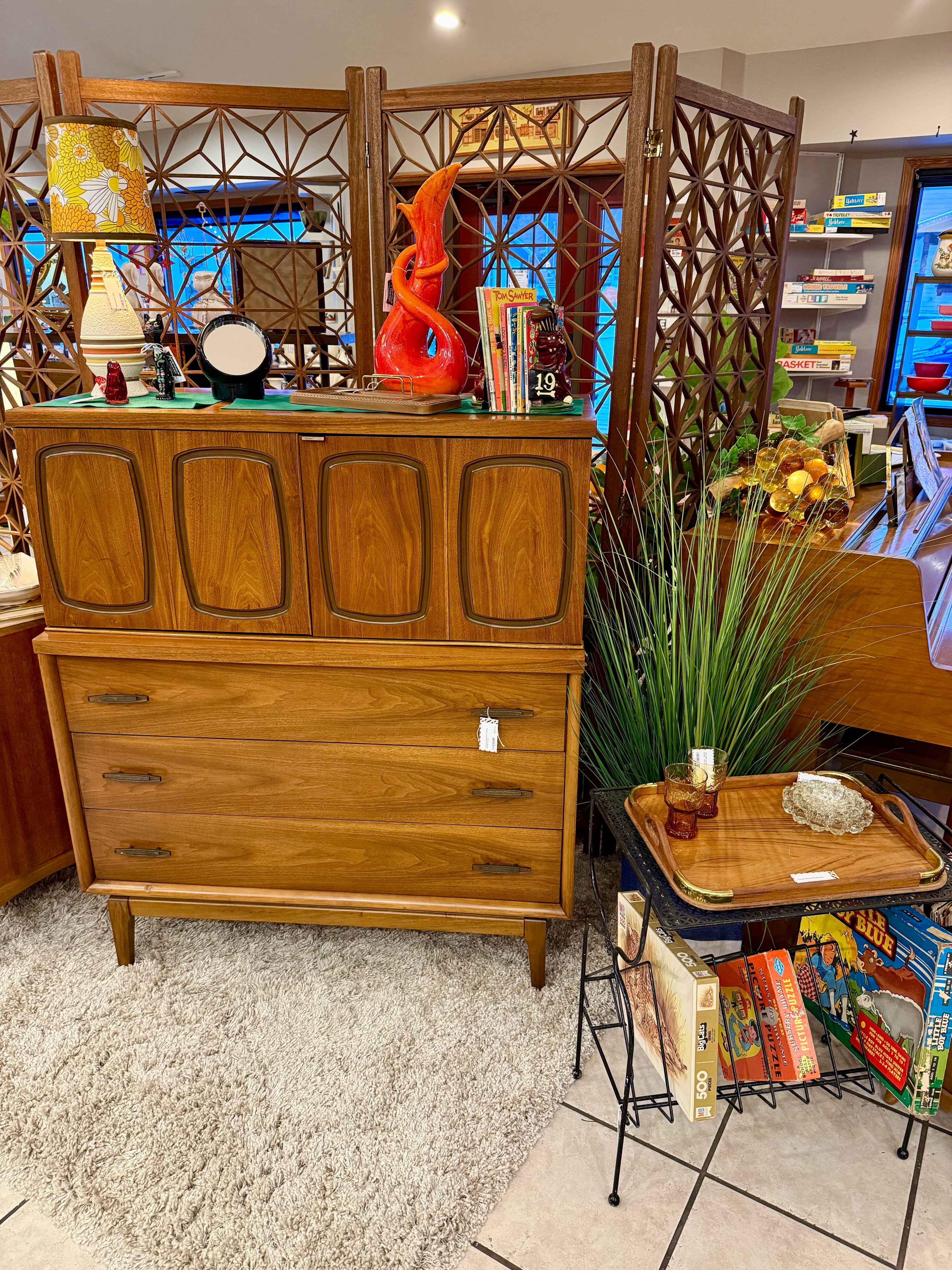 MCM dresser with other decor pieces shown in the store
